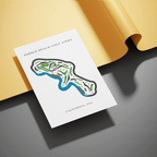 Map of Pebble Beach Golf Links on a white card with a yellow background
