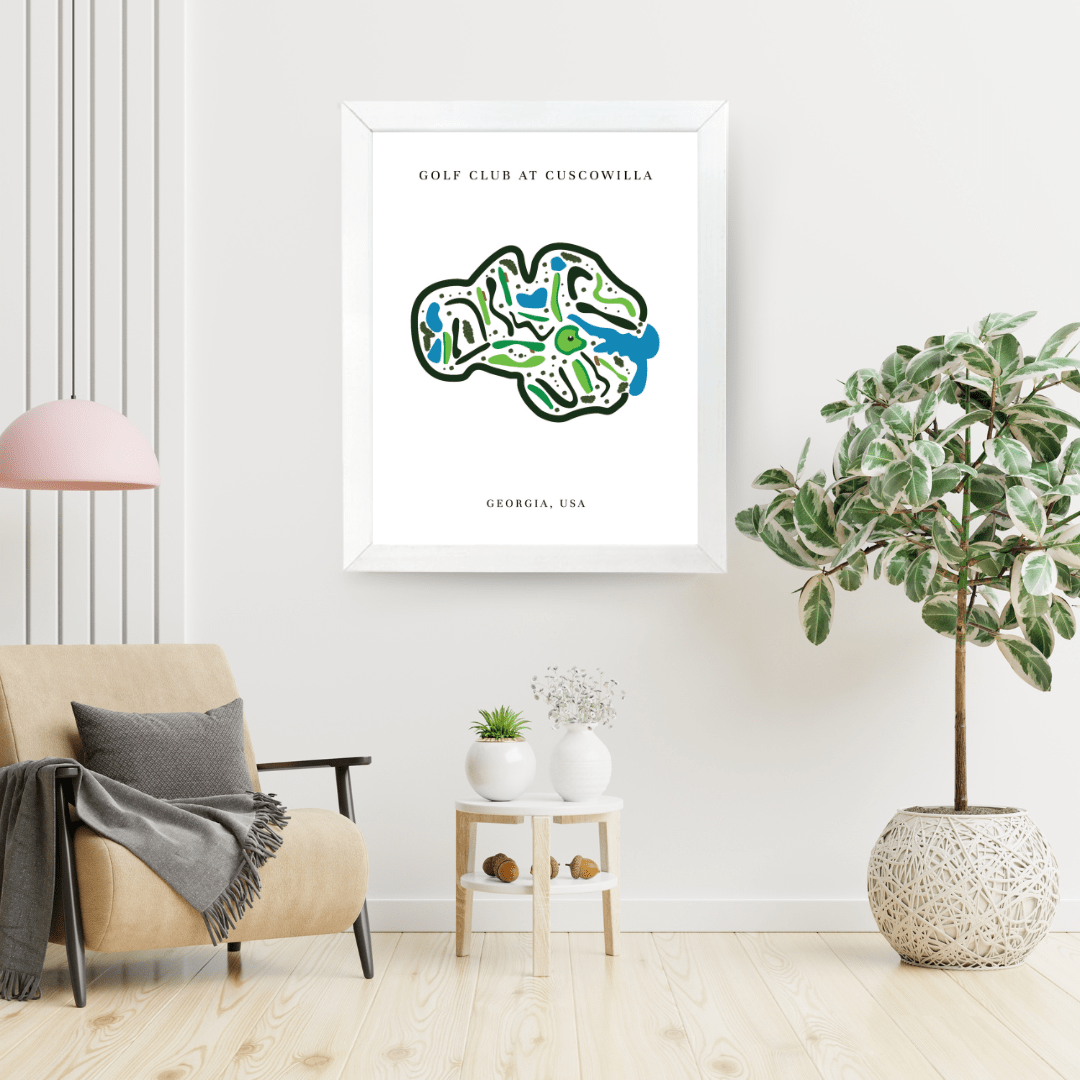Framed map of the Golf Club at Cuscowilla in Georgia, USA, in a living room setting with a beige armchair and potted plants.