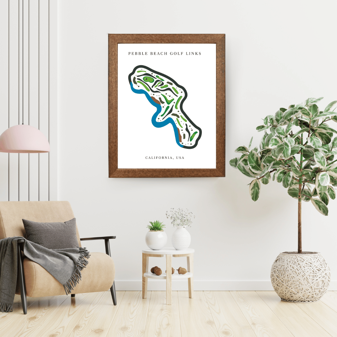 Framed map of Pebble Beach Golf Links in a living room setting with a plant and chair.