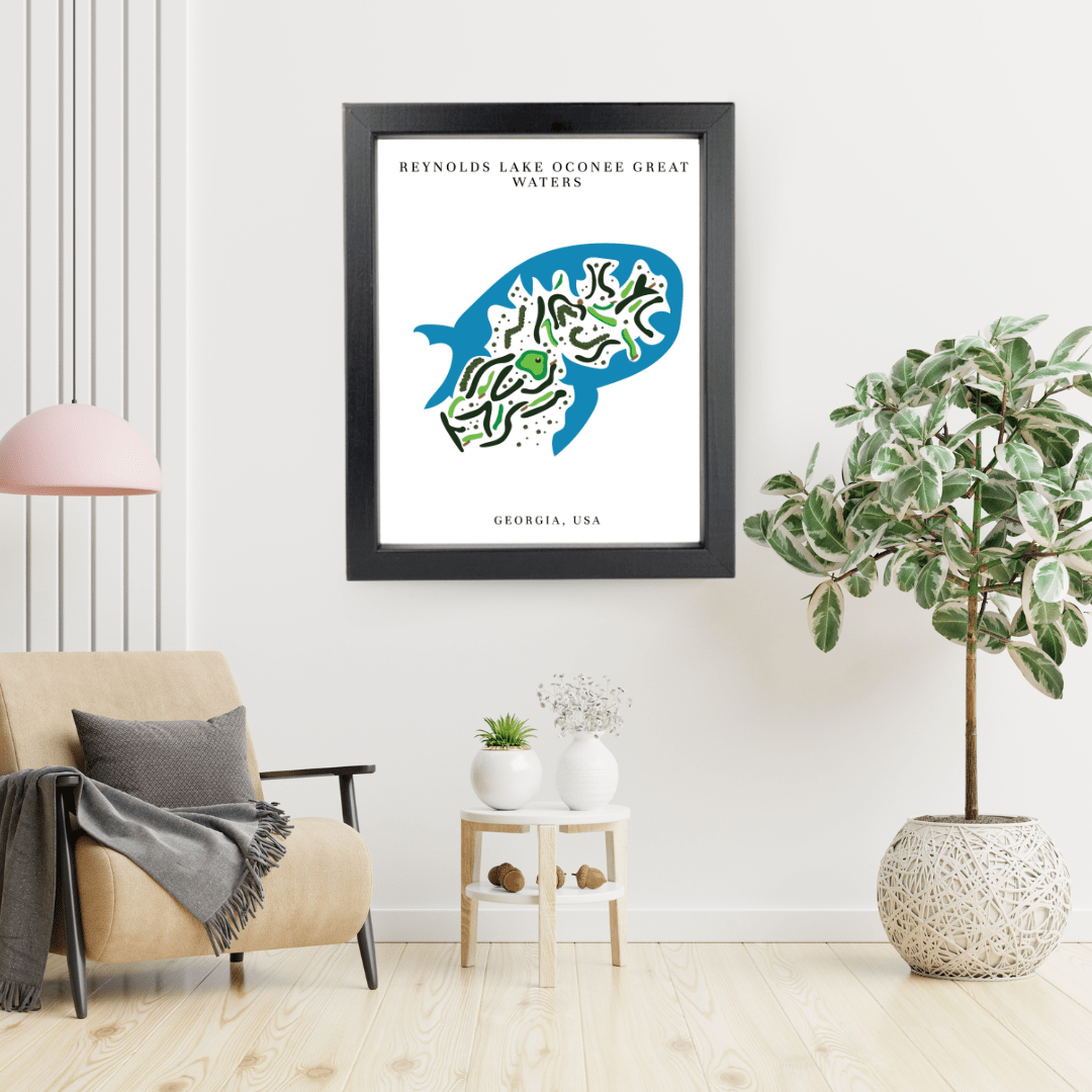 Framed artwork of a golf course map illustration on a wall in a living room with a chair and plants.