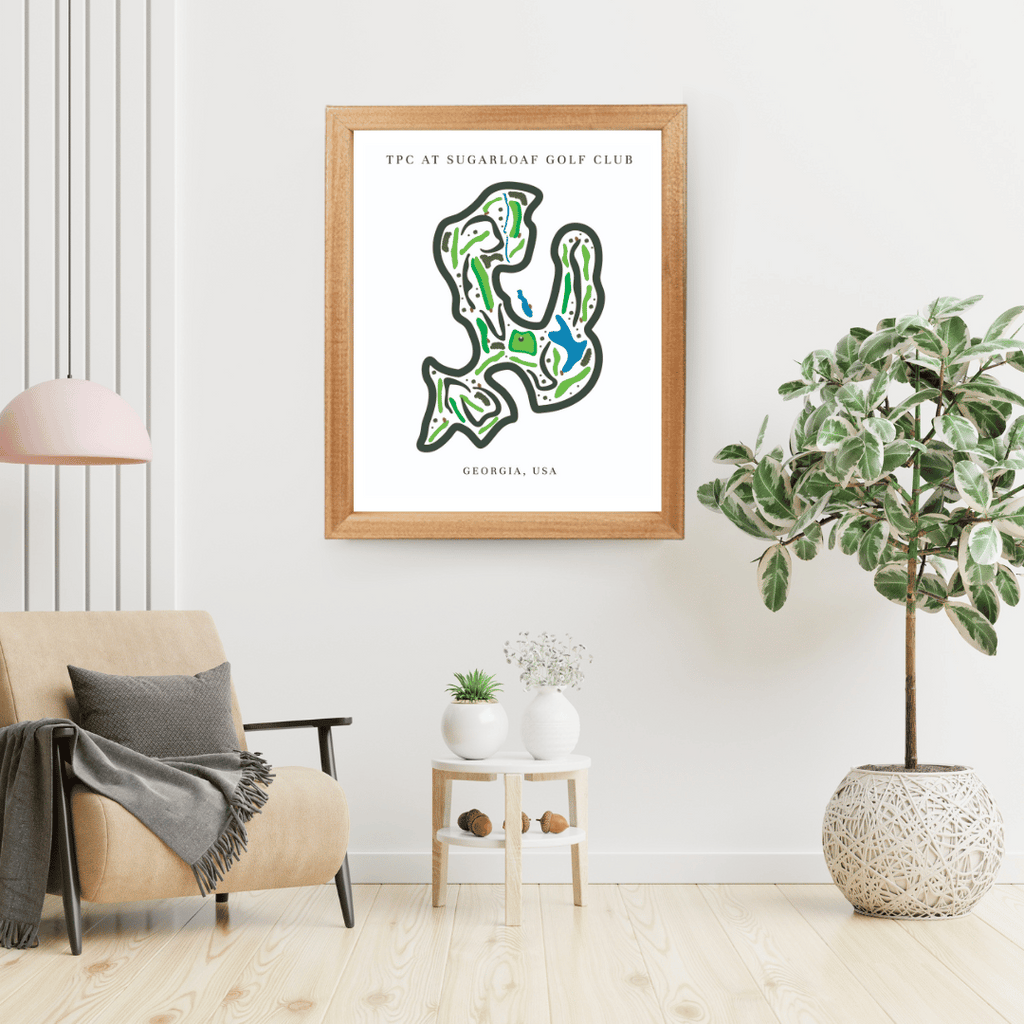 Framed golf course map on a wall in a living room with decor elements.